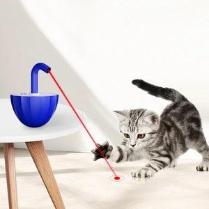 Automatic cat laser toy in blue showing red laser dot for pets playing on living room floor