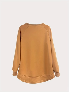 Detail view of mustard yellow sweatshirt back featuring a curved hem and ribbed trim