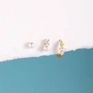 Close-up of gold plated s925 silver earring set with pearls and sparkling zircon stones