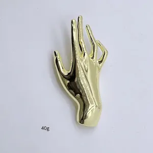 Golden hand shaped metal brooch pin for suits with 10.5cm height and polished finish