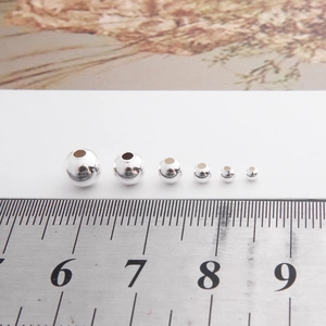 Polished S925 sterling silver round beads in various sizes with a scale reference