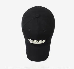 Top view of black cotton baseball cap showing six-panel stitching and white 3D embroidery