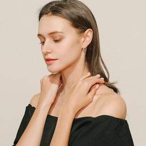 Model wearing vintage S925 sterling silver hoop earrings with hollow heart and turquoise