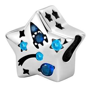 Macro shot of silver star charm pendant featuring deep and light blue zircon stones
