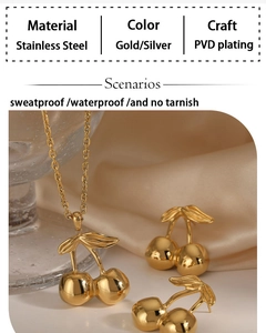 Macro detail of gold stainless steel cherry jewelry set with PVD plating on silk