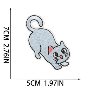 Detail showing a light blue cat embroidered patch with precise 5x7cm dimensions