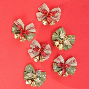 Detail of Christmas burlap bows with metal bells and festive Merry Christmas print