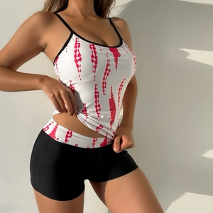 Detail of high-waist tankini set featuring rose red tie-dye print top and black boy shorts