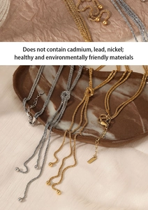 Macro detail of multi-layer gold and silver steel necklaces on a ceramic plate
