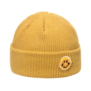 Detail of yellow ribbed knit beanie with a textured plush smiley face patch for winter