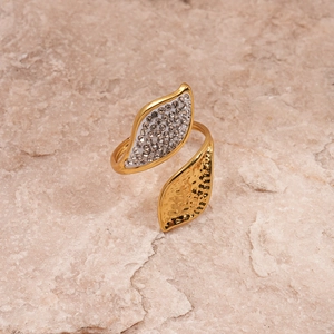 Detailed macro view of gold leaf ring featuring sparkling zircon and hammered texture