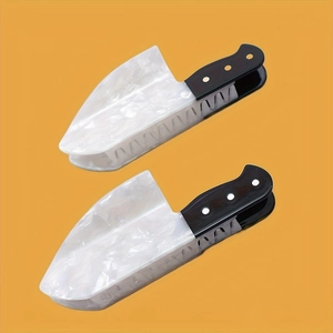 Detailed macro view of two acrylic cleaver hair clips with white marble texture on a yellow background