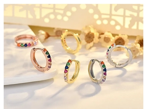 Close-up of rainbow cubic zirconia hoop earrings in gold, rose gold and silver finishes