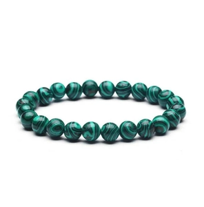 Macro shot of 8mm green malachite stone beads bracelet with natural striped patterns