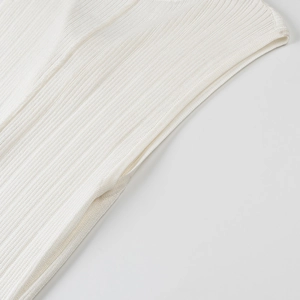 Detailed close-up of ivory white ribbed knit fabric and precise side seam stitching