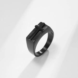 Men's matte black stainless steel signet ring with a raised 3D cross and radial texture