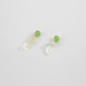 Long shell tassel earrings with green studs and gold rings on white background