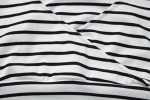 Detailed macro view of the V-neck knit fabric with black and white striped texture