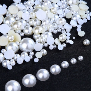 Macro shot of assorted white and beige ABS wrinkled imitation pearls for DIY jewelry crafts