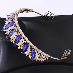 Detailed view of bridal crown with deep blue rhinestones and side hair combs for secure fit