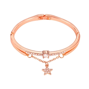 Rose gold bangle with sparkling star pendant and rhinestones on a clean white background