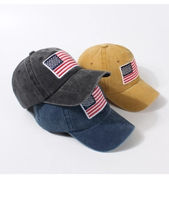 Detail of embroidered American flag patches on washed cotton baseball caps in various colors