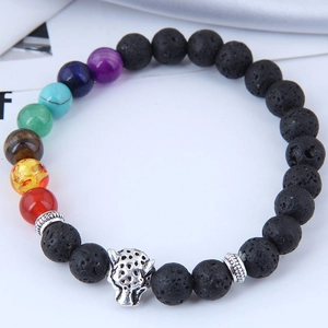 Lava rock stone bracelet with chakra beads and silver leopard head charm on white background