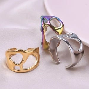 Detailed shot of irregular cutout liquid metal rings in gold, silver, and rainbow finishes