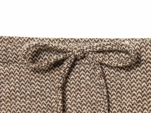 Dettaglio macro del tessuto in tweed a spina di pesce marrone con vita a coulisse