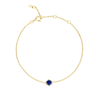 Macro view of gold-plated S925 silver chain with a blue zircon pendant and S925 hallmark