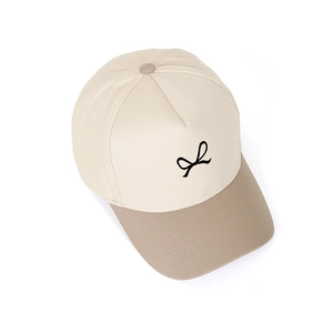 Close-up of a 5-panel trucker hat with bow embroidery and two-tone color block design