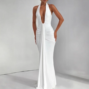Detail view of deep V-neckline and waist pleats on white halter maxi dress