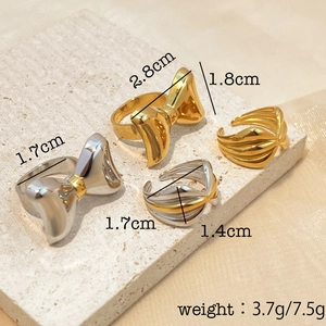 Two-tone gold and silver bow ring and wave band set with detailed size and weight specs