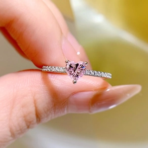 Macro shot of S925 silver ring featuring heart-shaped pink diamond and side accents