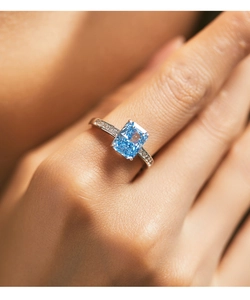 Close-up of S925 sterling silver ring with blue square gemstone worn on a finger
