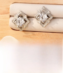 Detailed view of silver vintage baroque earrings with zircon and engraved steel accents