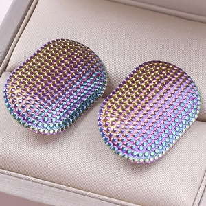 Macro shot of oval 304 stainless steel earrings with dot texture and iridescent finish