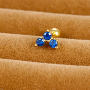 Macro detail of royal blue zircon flower crown stud with golden screw ball back