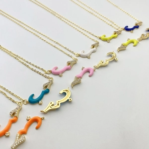 Detailed close-up of Arabic love calligraphy necklaces in colorful enamel and gold finish