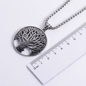 Silver Tree of Life stainless steel necklace pendant shown with measurement ruler