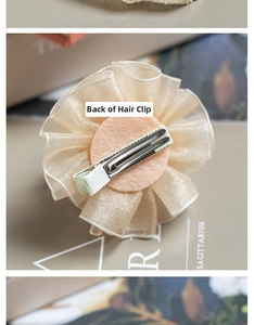 Detail of champagne organza flower hair clip back with felt base and metal duckbill clip