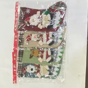 Detail showing set of 4 3D character Christmas stockings in plastic packaging
