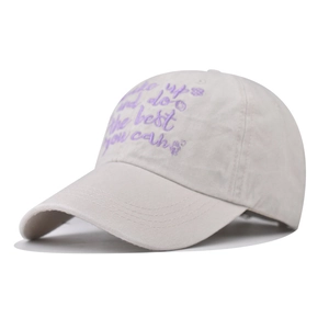 Detail of purple embroidery on cream washed cotton baseball cap with stitched brim