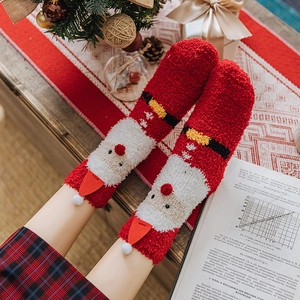 Cozy 3-pack Christmas coral fleece socks featuring Santa Claus designs and plush pom-poms