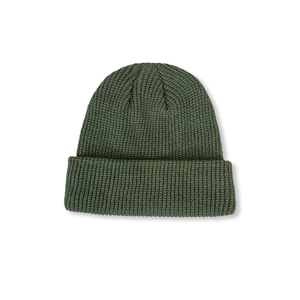 Close-up of thick dark green knit beanie featuring a classic ribbed texture and warm cuff