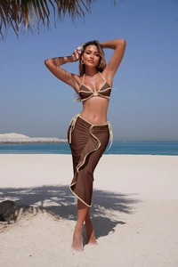 Chic coffee brown bikini top and matching tie-waist sarong skirt set at a sunny beach resort