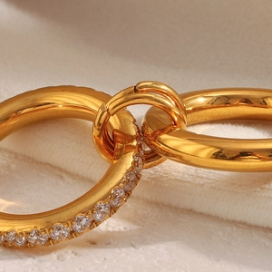 Close-up of 18K gold-plated double-loop ring with micro-pave cubic zirconia inlay