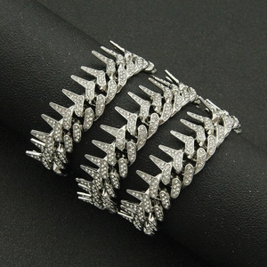 Detail of silver hip hop Cuban chain with spiked arrow links and paved rhinestones