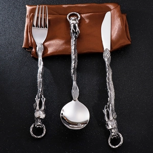 Detailed view of punk style silver cutlery with intricate dragon sculpture handle design