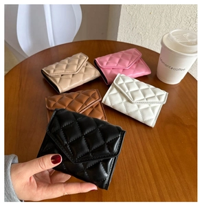 Detailed view of quilted PU leather wallets in black, brown, beige, white, and pink